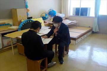 通知票を渡しています。