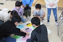 模造紙に標語を貼る児童の写真