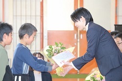 花束を渡す児童の写真